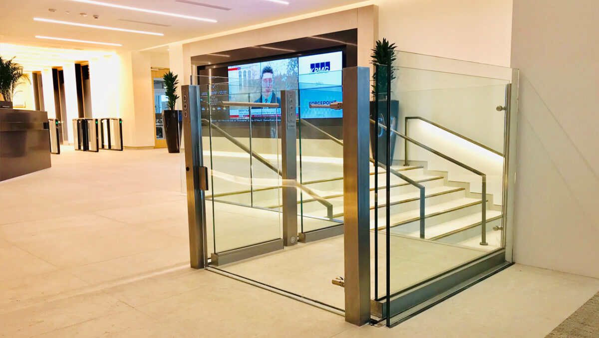 Modern Lyfthaus platform lift with glass and steel, integrated into a bright office lobby.