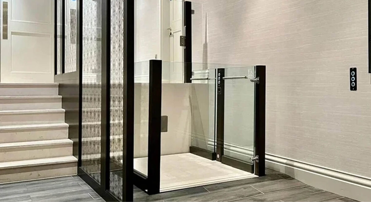 A stairlift in a white tiled building - Lyfthaus