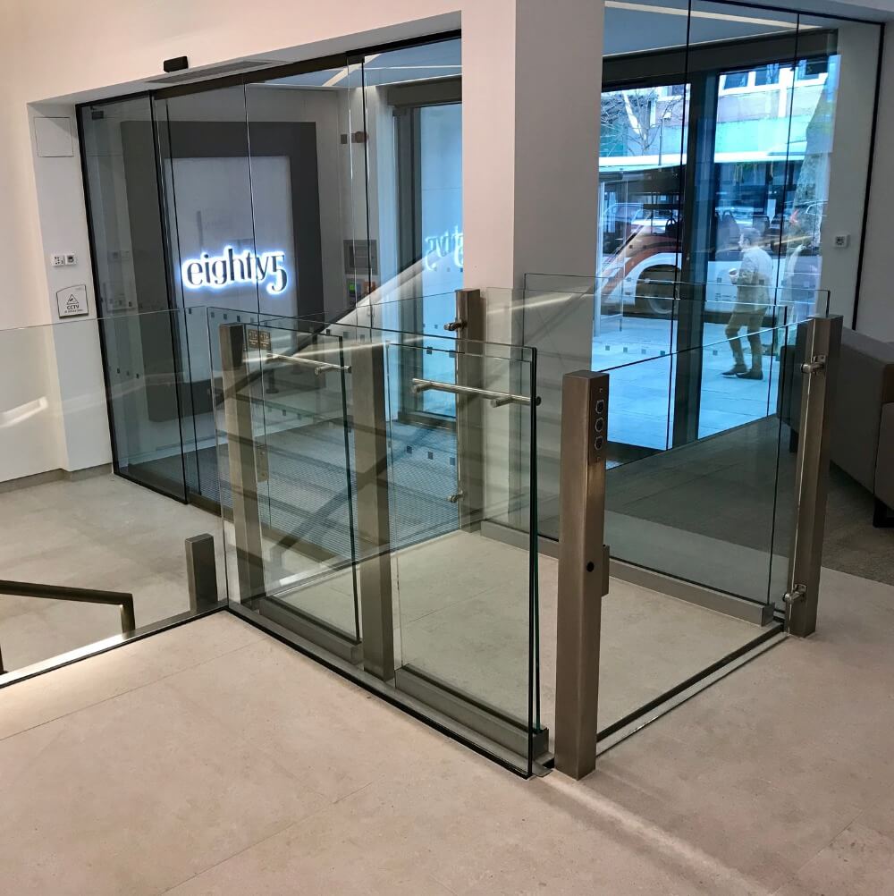 A hotel lobby with a glass and chrome Lyfthaus stairlift