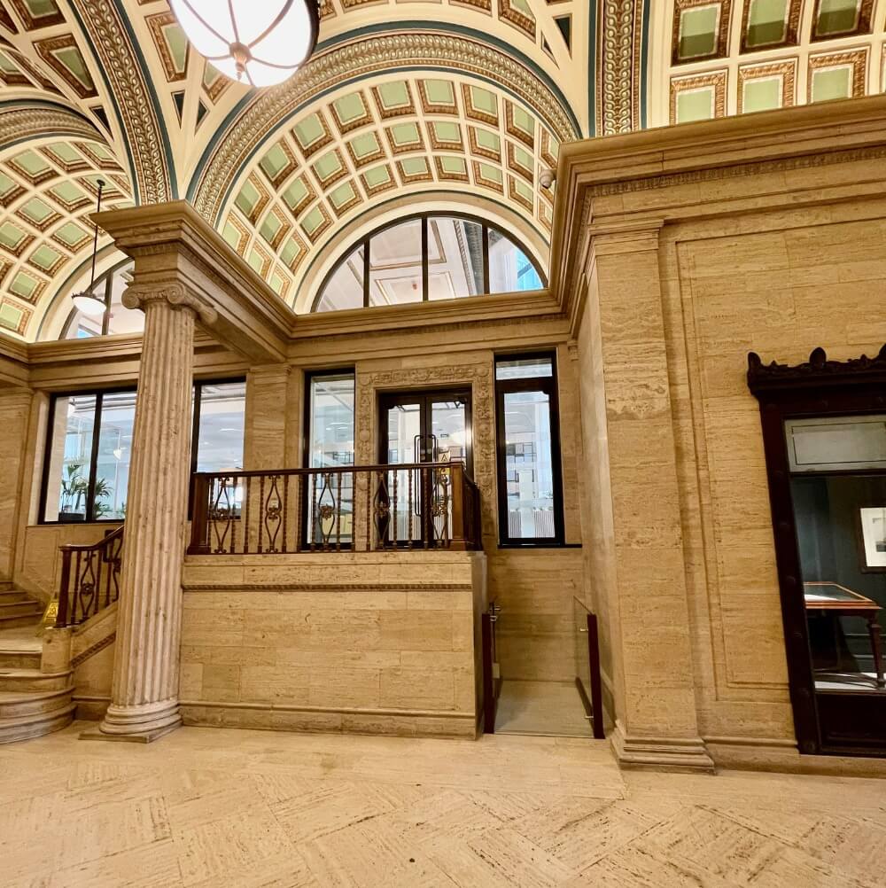 A beautiful sandstone museum lobby with a Lyfthaus stairlift