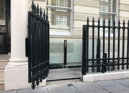 A platform lift at street level with the gate open - Lyfthaus